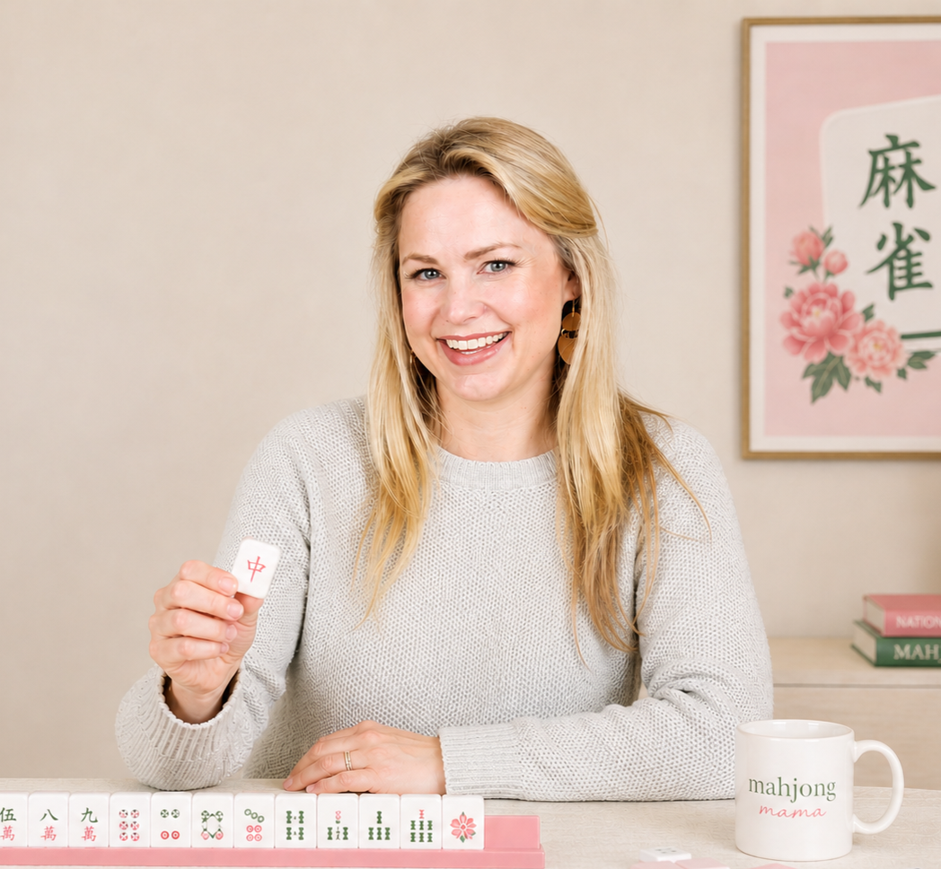 Jennifer, founder of Game Set Mahj, holding a mahjong tile